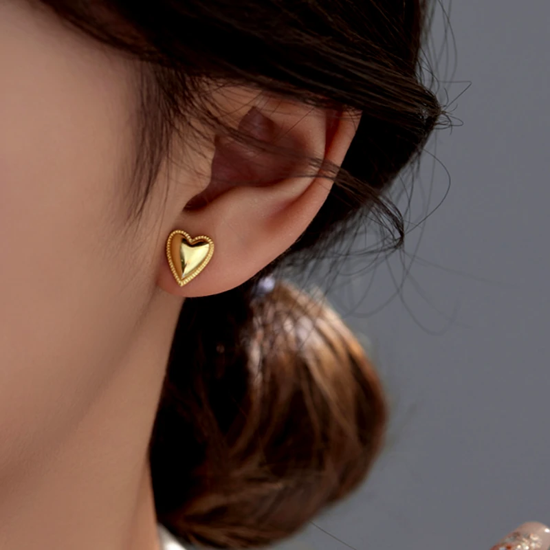 Model showcasing the dangle and style of the Sterling Silver Elegant Heart Studs
