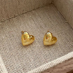 Model showcasing the dangle and style of the Sterling Silver Elegant Heart Studs