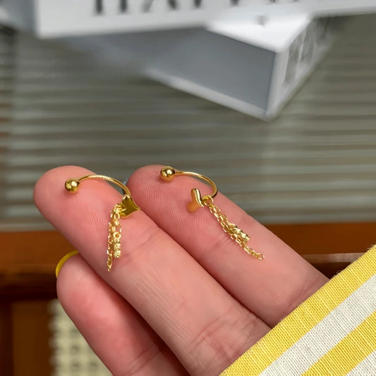 Model showcasing the dangle and style of the Sterling Silver Elegant Heart Tassel Jacket Earrings