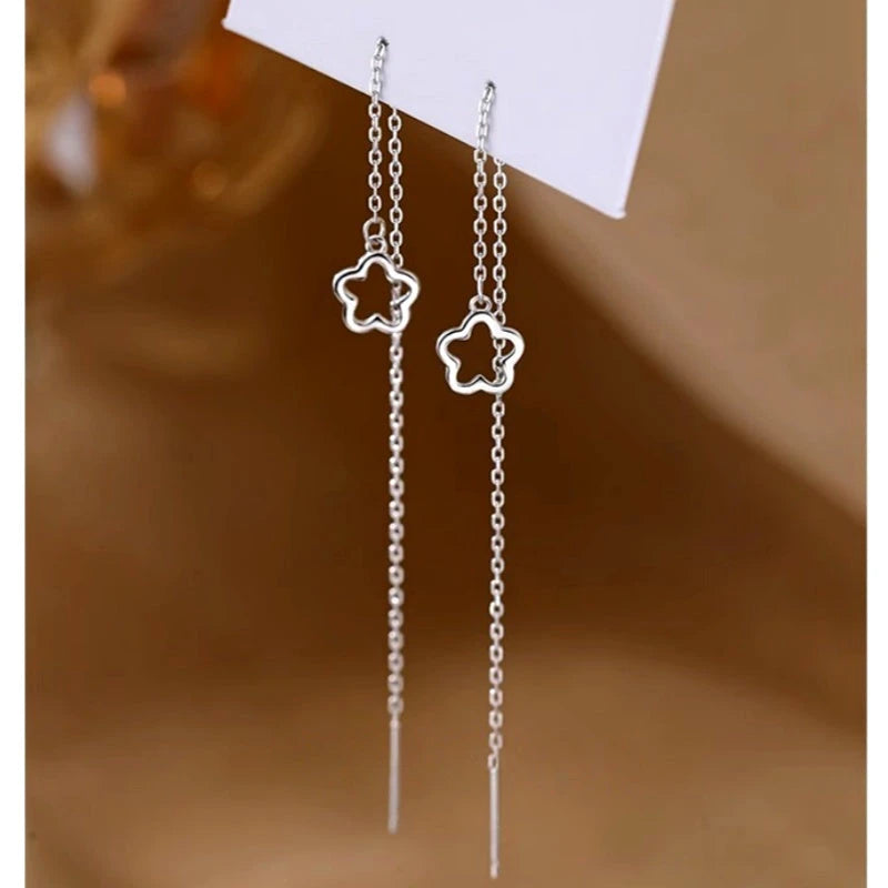 Model showcasing the dangle and style of the Sterling Silver Elegant Hollow Flower Threader Earrings