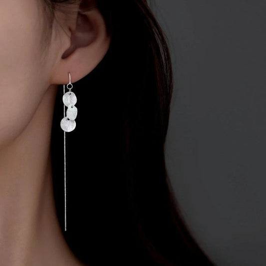 Model showcasing the dangle and style of the Sterling Silver Elegant Multi-Disc Threader Earrings