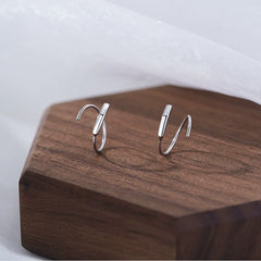 Model showcasing the dangle and style of the Sterling Silver Elegant Simple Spiral Earrings