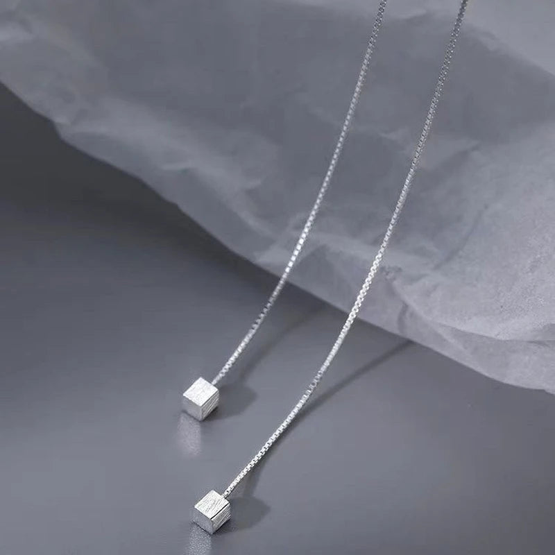 Close-up detail of the sparkling zircons and plating on the Square Threader Earrings