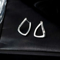 Model showcasing the dangle and style of the Sterling Silver Elegant Twisted Geometric Earrings