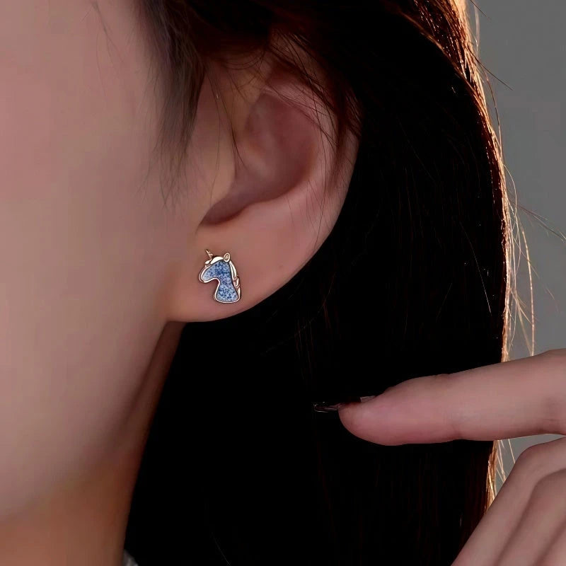 Model showcasing the dangle and style of the Sterling Silver Elegant Unicorn Studs