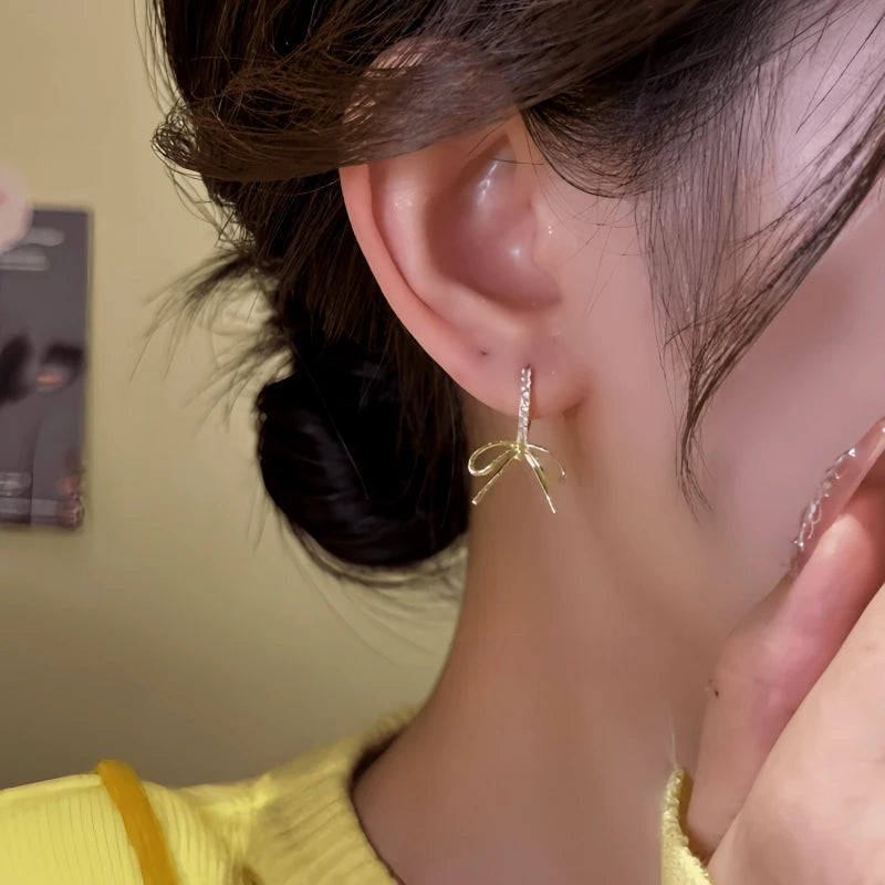 Close-up detail of the sparkling zircons and plating on the Zircon Bow Earrings