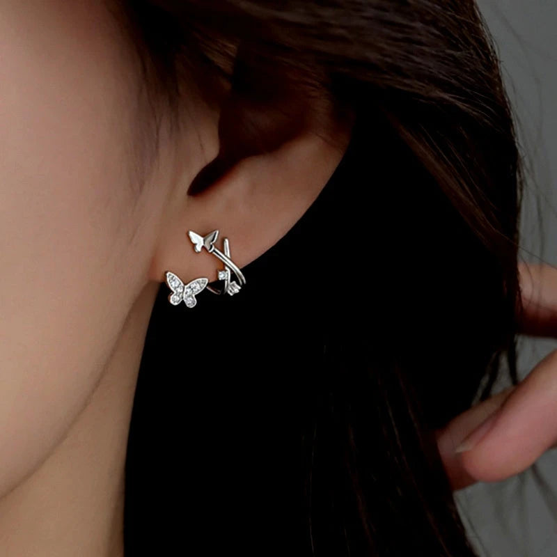 Model showcasing the dangle and style of the Sterling Silver Elegant Zircon Butterfly Stud Earrings