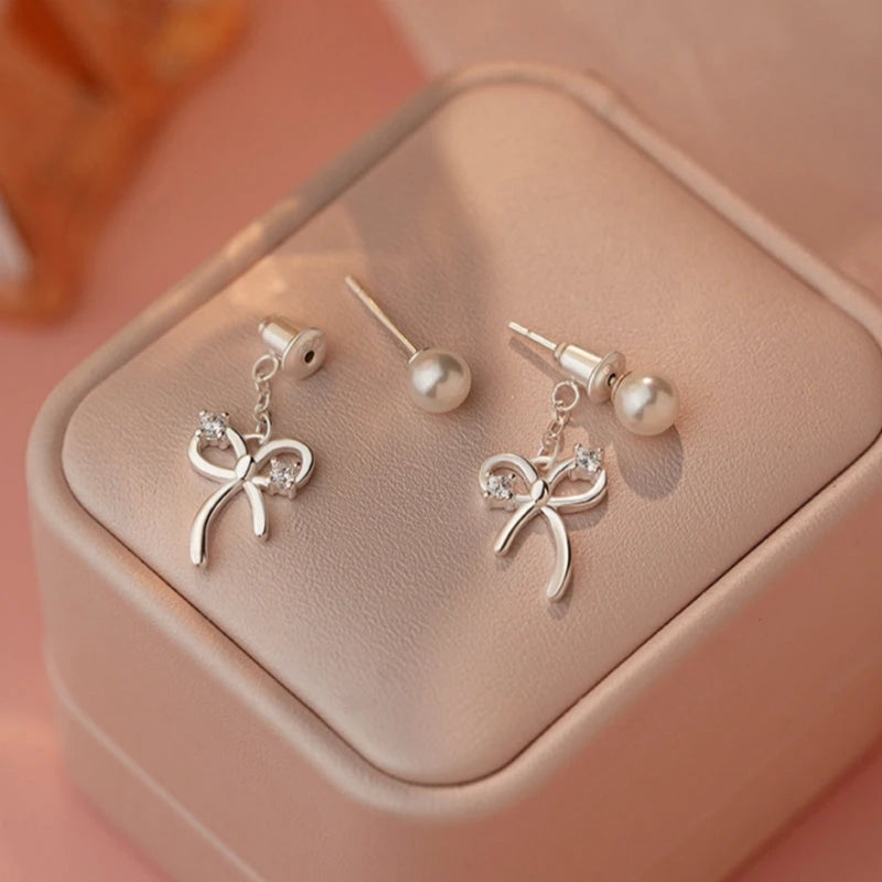 Close-up detail of the sparkling zircons and plating on the Bow Pearl Earrings