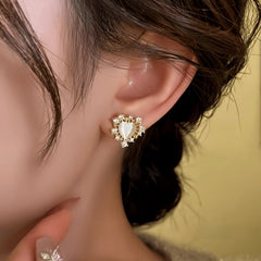 Model showcasing the dangle and style of the 14K Gold-Plated Elegant Zircon Heart Stud Earrings