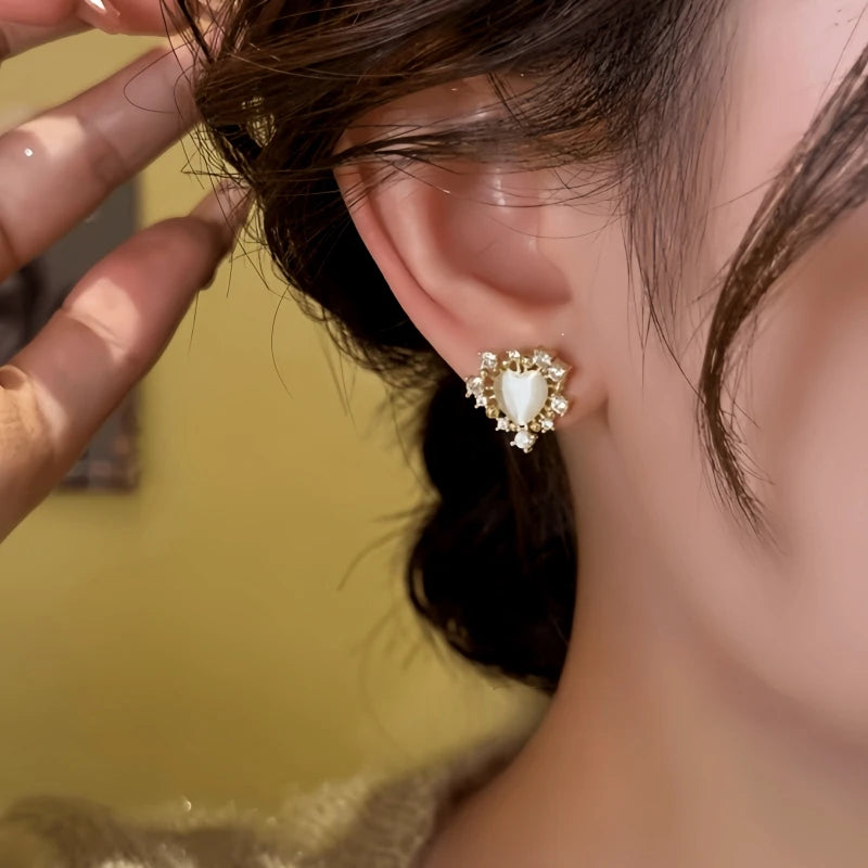Close-up detail of the sparkling zircons and plating on the silver heart earrings