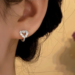 Model showcasing the dangle and style of the Sterling Silver Elegant Zircon Little Heart Hoop Earrings