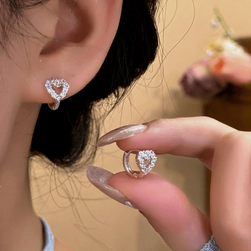 Angled view of the Sterling Silver Elegant Zircon Little Heart Hoop Earrings