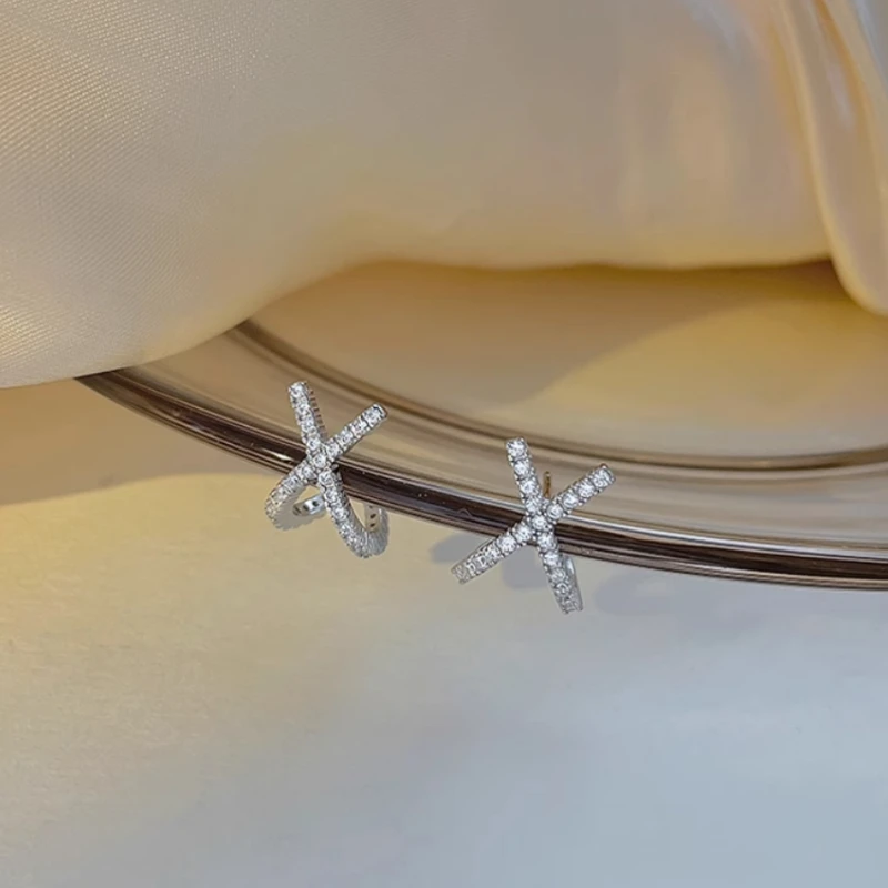 Close-up detail of the sparkling zircons and plating on the Letter Stud Earrings