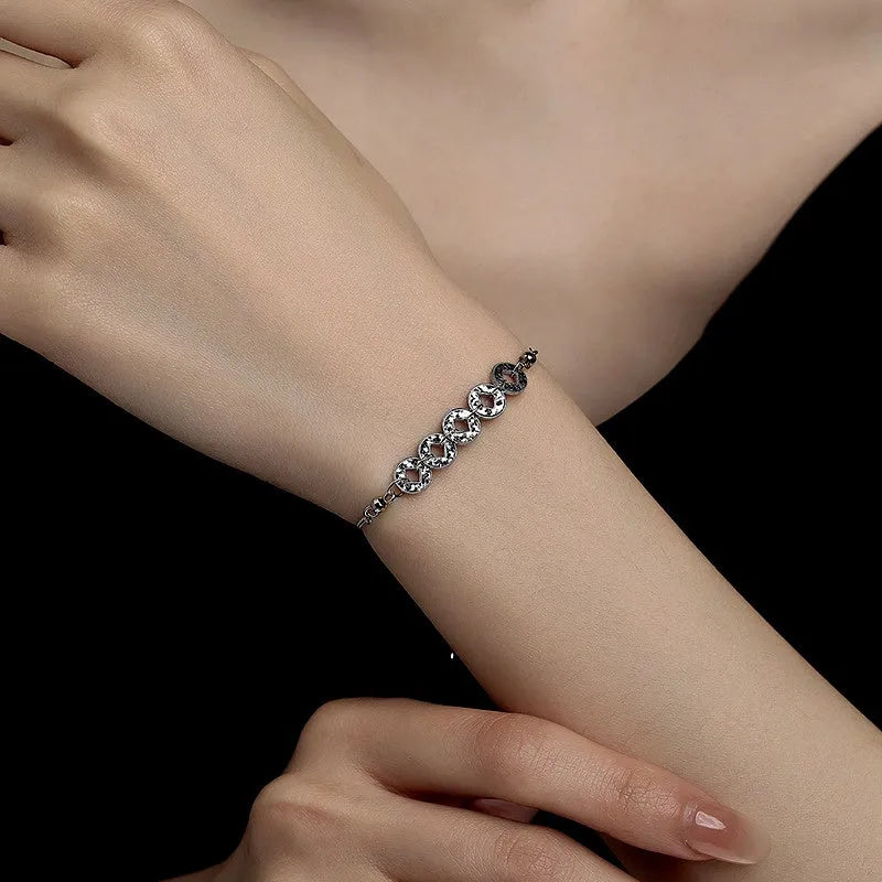 Model wearing the Sterling Silver Five Emperors Coin Bracelets to highlight its design on the wrist