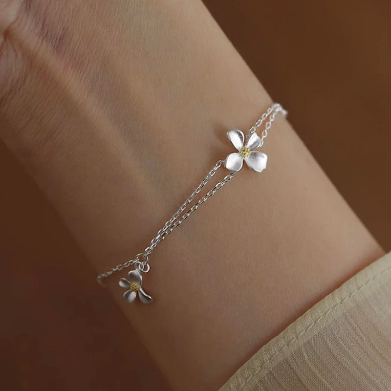 Model wearing the Sterling Silver Flower Bracelet to highlight its design on the wrist