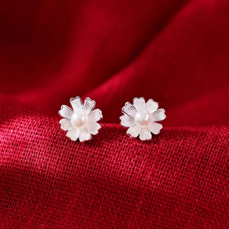 Close-up detail of the sparkling zircons and plating on the Flower Pearl Studs