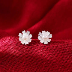 Close-up detail of the sparkling zircons and plating on the Flower Pearl Studs