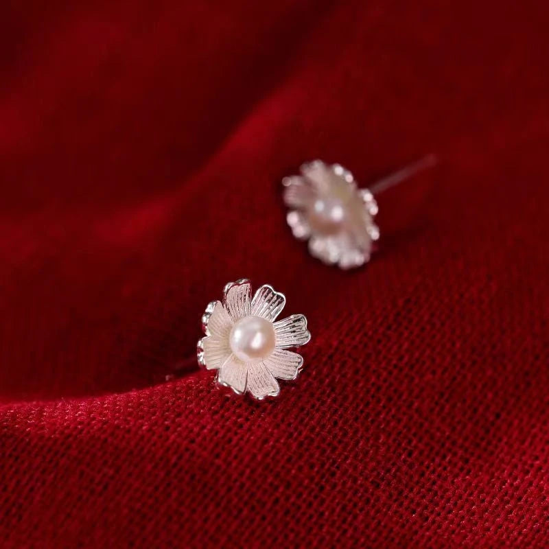Angled view of the Sterling Silver Flower Pearl Stud Earrings