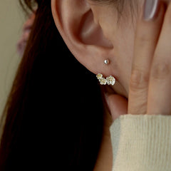 Close-up detail of the sparkling zircons and plating on the Flower Screw Earrings