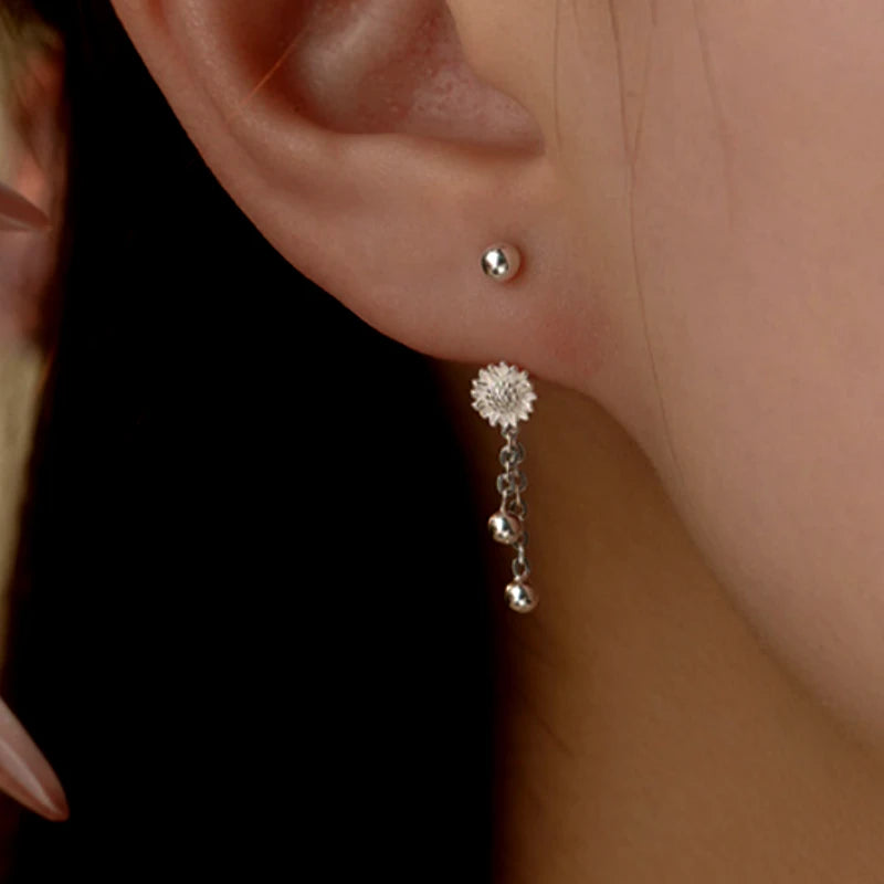 Angled view of the Sterling Silver Flower Screw Tassel Earrings