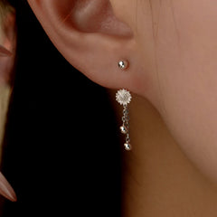 Angled view of the Sterling Silver Flower Screw Tassel Earrings