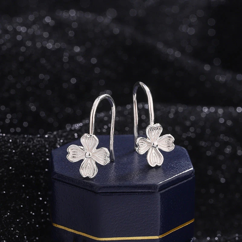 Model showcasing the dangle and style of the Sterling Silver Four-Leaf Flower Ear Hooks
