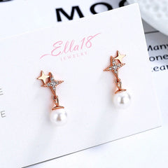 Angled view of the Sterling Silver Four-Pointed Star Pearl Earrings