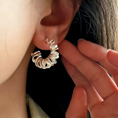 Model showcasing the dangle and style of the Sterling Silver Frosted Telephone Wire Earrings