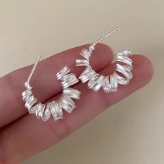 Angled view of the Sterling Silver Frosted Telephone Wire Earrings