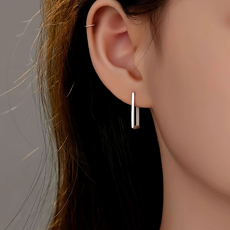 Model showcasing the dangle and style of the Sterling Silver Geometric Rectangular Earrings