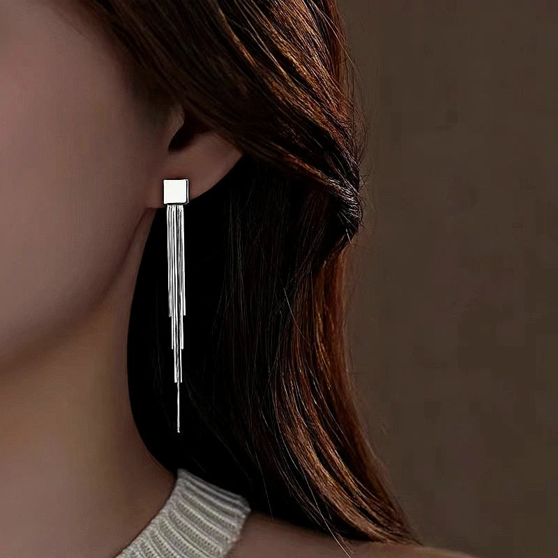 Model showcasing the dangle and style of the Sterling Silver Geometric Square Tassel Earrings