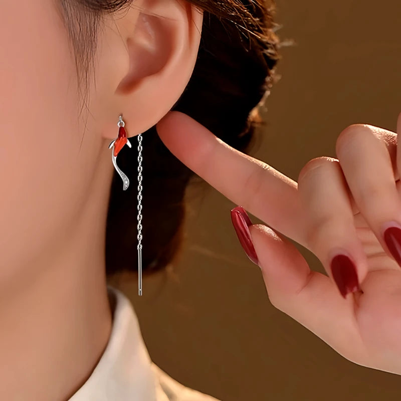 Angled view of the Sterling Silver Gold Fish Threader Earrings