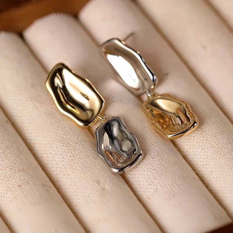 Angled view of the Sterling Silver Golden And Silver Drop Earrings