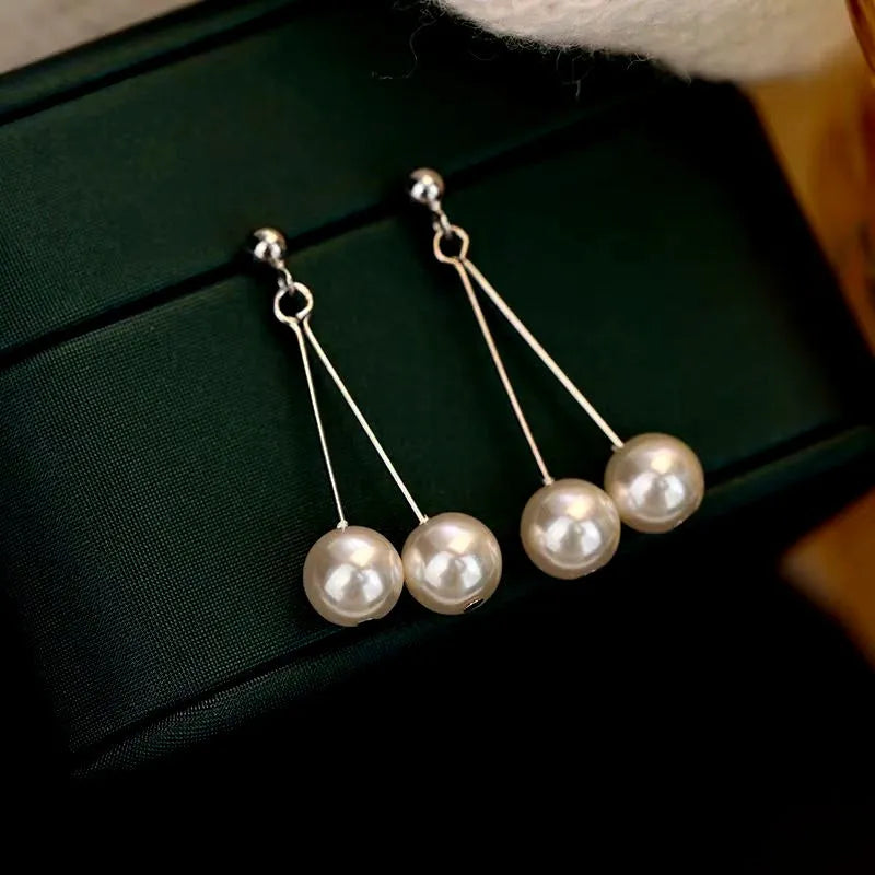 Close-up detail of the sparkling zircons and plating on the Double Pearl Earrings