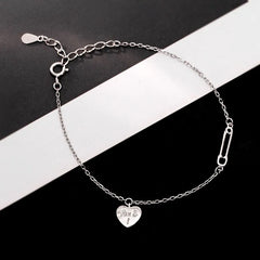 Close-up of the clasp and charm details on the Heart Paper Clip Bracelet