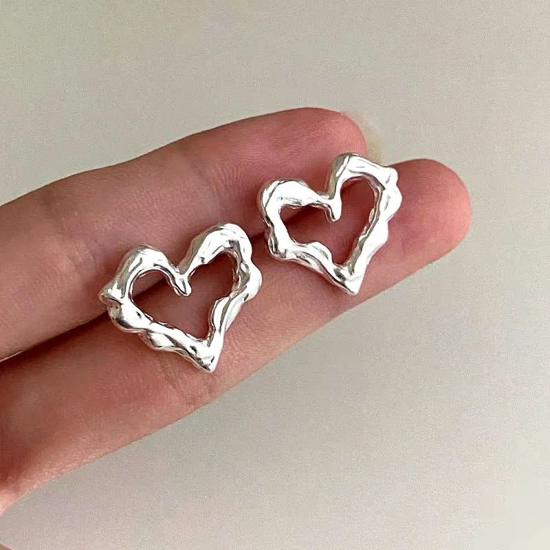 Angled view of the Sterling Silver Heart-Design Stud Earrings