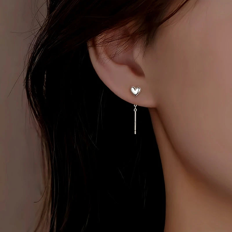 Model showcasing the dangle and style of the Sterling Silver Heart-Design Threader Earrings