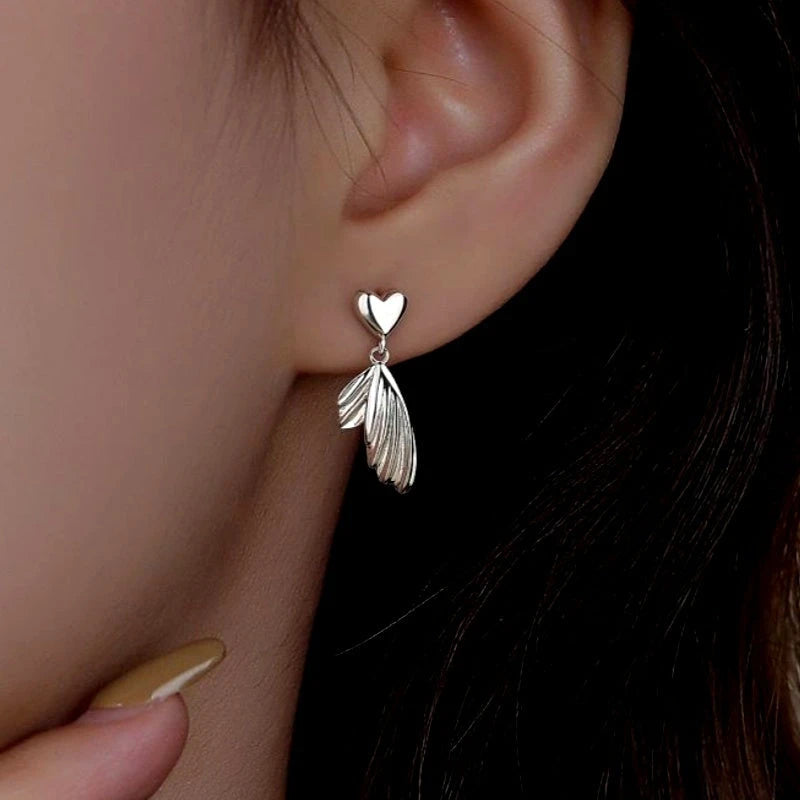 Close-up detail of the sparkling zircons and plating on the Heart Fishtail Earrings