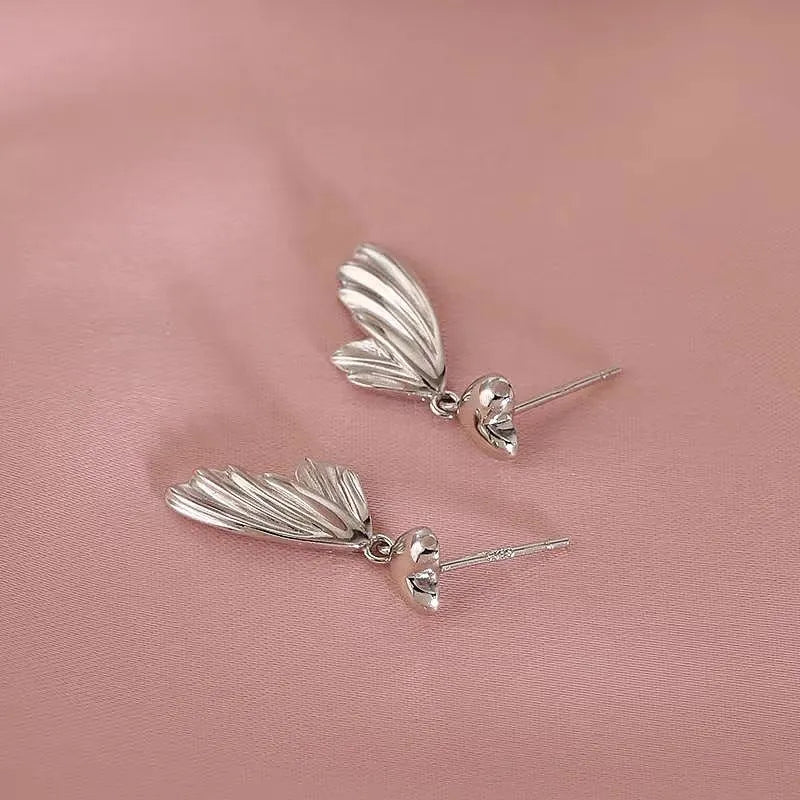 Angled view of the Sterling Silver Heart Fishtail Earrings