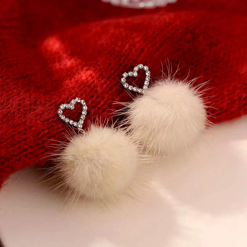 Angled view of the Sterling Silver Heart Hair Ball Earrings