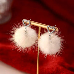 Model showcasing the dangle and style of the Sterling Silver Heart Hair Ball Earrings