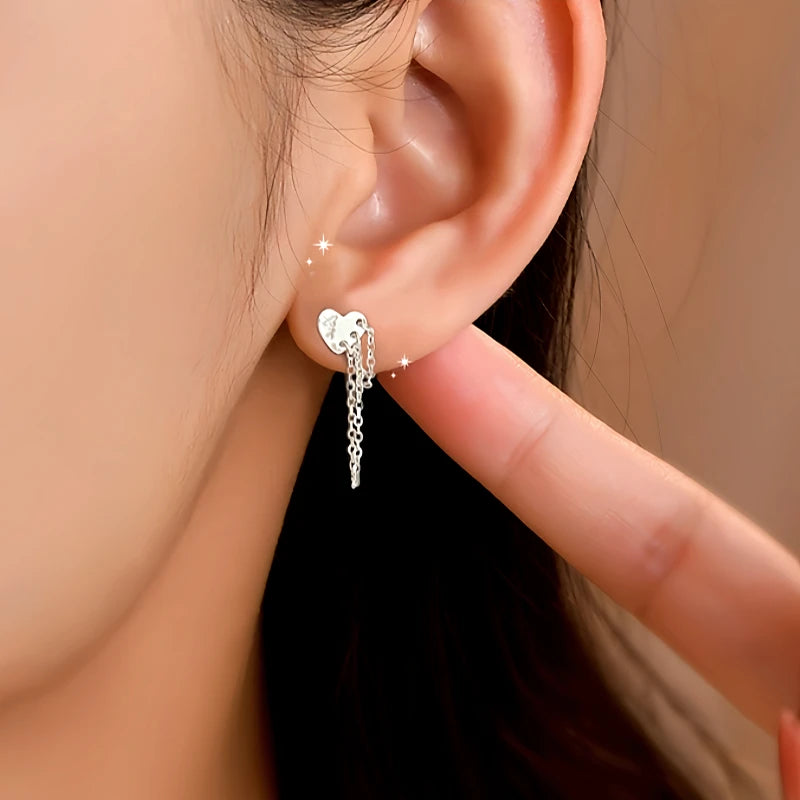 Close-up detail of the sparkling zircons and plating on the Heart Tassel Earrings