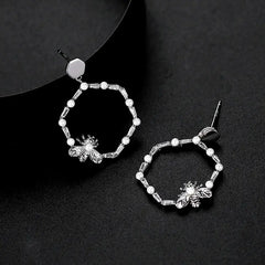 Model showcasing the dangle and style of the Sterling Silver Hollow Bee Earrings