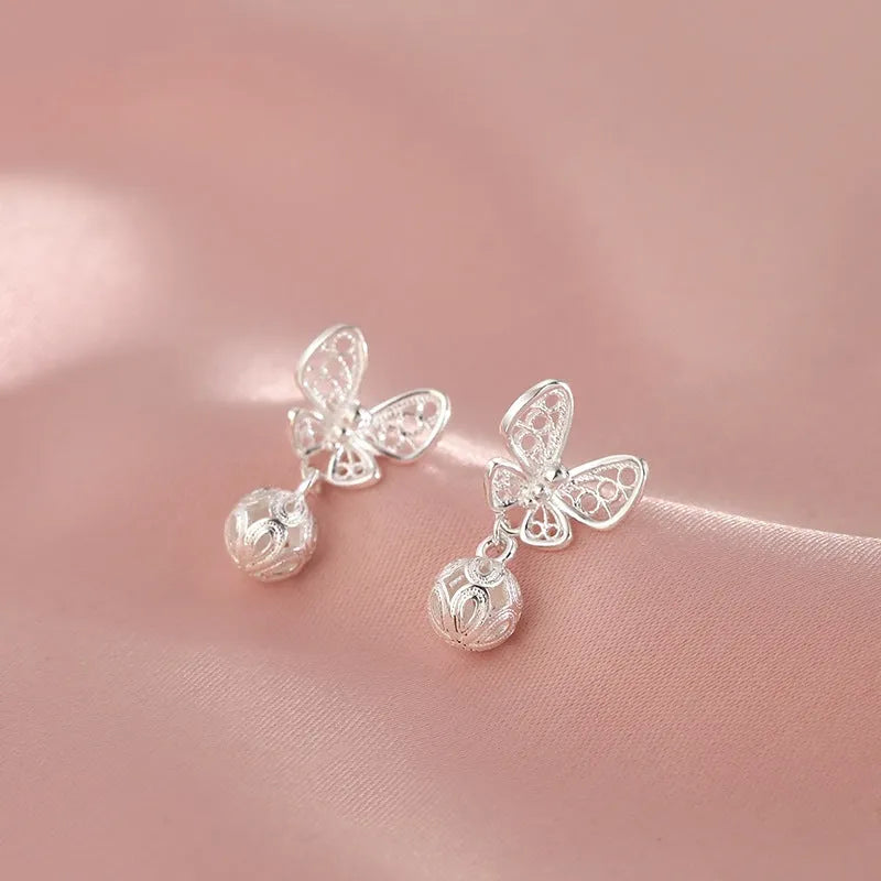 Angled view of the Sterling Silver Hollow Butterfly Earrings