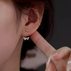 Model showcasing the dangle and style of the Sterling Silver Hollow Butterfly Jacket Earrings