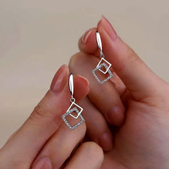 Angled view of the Sterling Silver Hollow Diamond Earrings