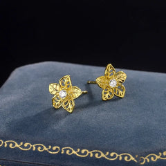 Model showcasing the dangle and style of the Sterling Silver Hollow Flower Stud Earrings