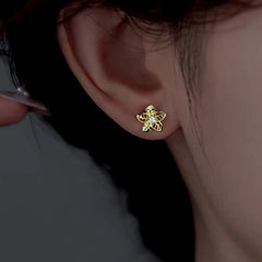 Angled view of the Sterling Silver Hollow Flower Stud Earrings