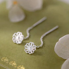 Model showcasing the dangle and style of the Sterling Silver Hollow Flower Threader Earrings