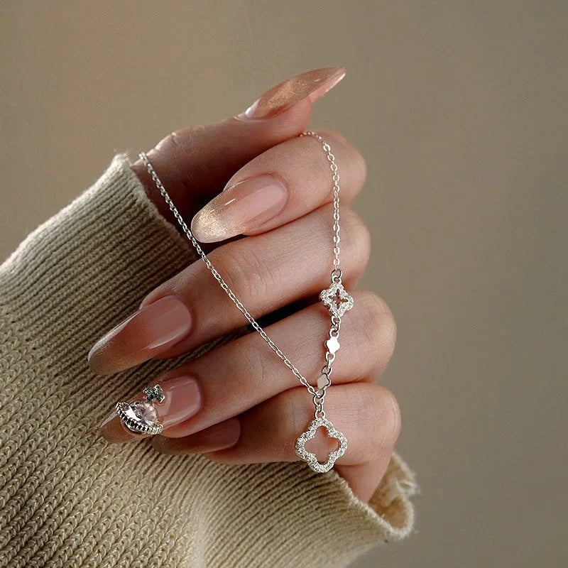 Sterling Silver Hollow Four-Leaf Flower Necklace worn to showcase its length and pendant detail